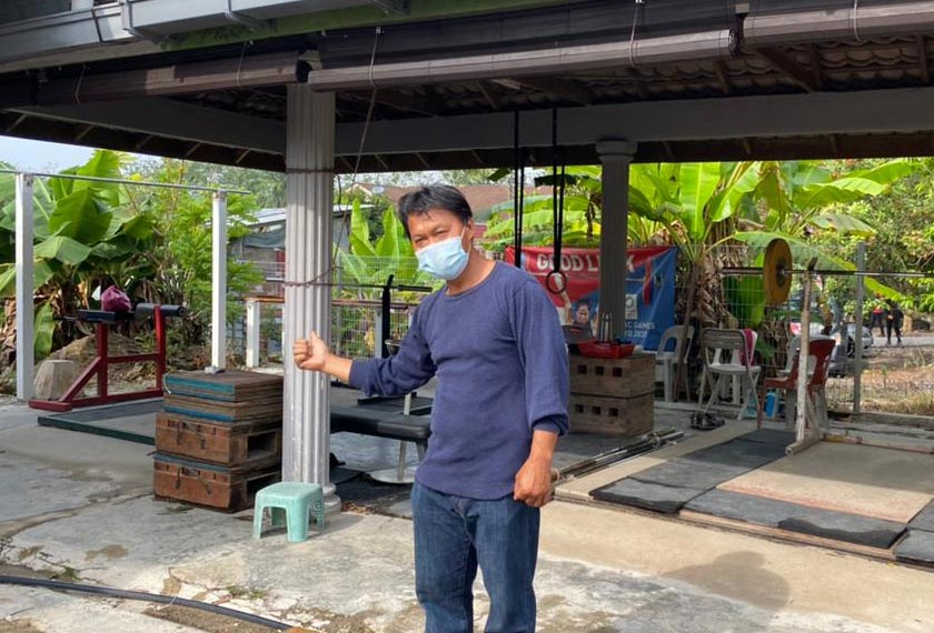   Ahmad Janius menunjukkan kawasan garaj di Kampung Kesang Tua, Jasin, Melaka yang menjadi medan latihan atlet angkat berat. - Astro AWANI