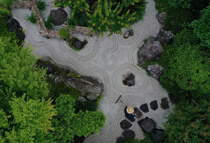 A gardener makes wave-shaped patterns, known as 'samon', at Karesansui, a traditional Japanese Dry Landscape, at Takao Komagino Garden in Hachioji, on the outskirts of Tokyo, Japan. REUTERSpic