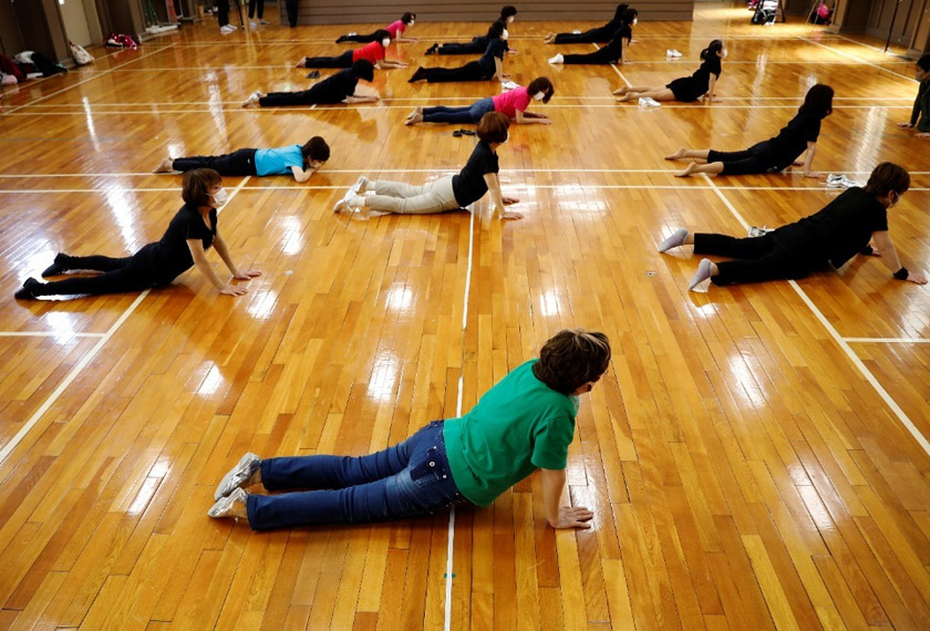 Fumie Takino, 89, the founder of a senior cheer squad called Japan Pom Pom, wears a protective face mask as she stretches with other members of Japan Pom Pom during a weekly practice session, amid the COVID-19 outbreak, in Tokyo, Japan. REUTERSpic