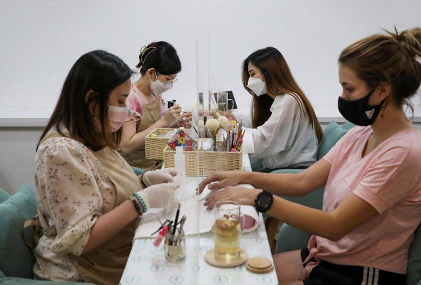 Nail salon Maniqure owner Lim Pei Xin works on a Squid Game's manicure for a client at her shop in Kuala Lumpur, Malaysia. - REUTERS