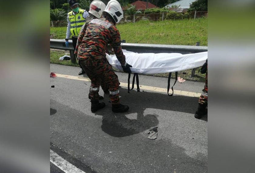 Anggota bomba bertugas mengangkat mayat mangsa untuk diserahkan kepada pihak polis. - Foto ihsan Bomba Perak