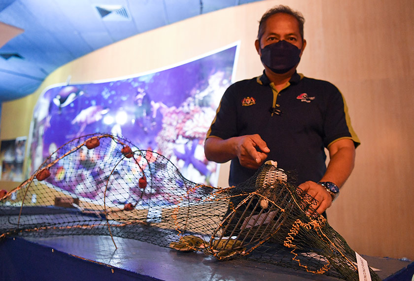 Pengarah Institut Penyelidikan Perikanan (FRI) Rantau Abang, Sharum Yusof menunjukkan cara penggunaan Peranti Penyisih Penyu (Turtle Excluder Device) pada pukat tunda sepanjang musim tengkujuh (November hingga Mac) semasa ditemui di FRI Kuala Abang di Dungun. - Foto BERNAMA
