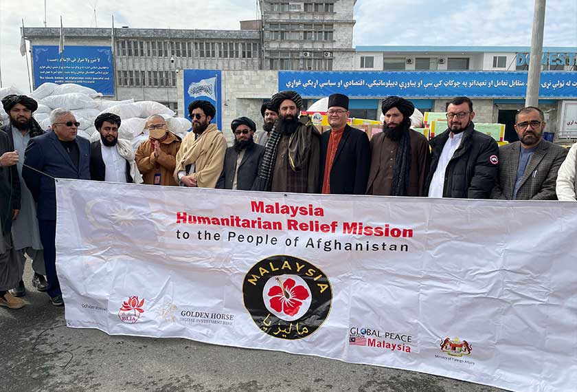 Ahmad Azam (dua, kiri) bergambar sempena program agihan bantuan di Kabul baru-baru ini. --fotoBERNAMA