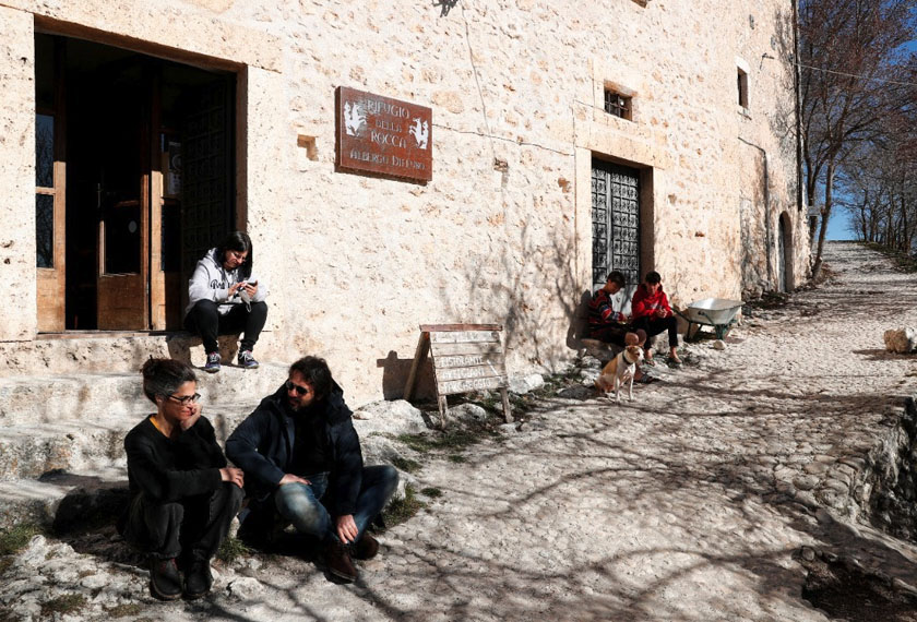 Residents of Rocca Calascio enjoy a sunny day in the small village of Rocca Calascio, Italy. - REUTERS