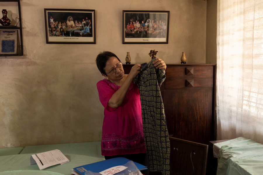 Cristina Bawagan, 67, shows the dress she wore when she was arrested, tortured and sexually abused by soldiers during the late Philippines' dictator Ferdinand Marcos's brutal era of martial law, in her home at Quezon City, Metro Manila, Philippines, April 22, 2022. Picture taken April 22, 2022.REUTERS/Eloisa Lopez