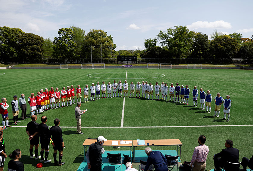 Players from Red Star, White Bear and Blue Hawaii attend the opening ceremony of the SFL (Soccer For Life) 80 League in Tokyo, Japan. - REUTERS