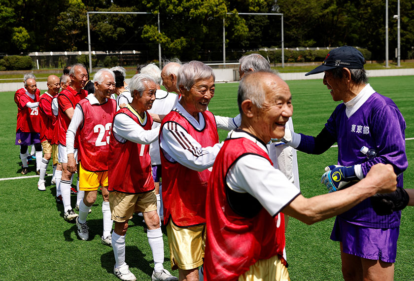 Red Star’s midfielder Mutsuhiko Nomura, 83, and White Bear’s goalkeeper Shingo Shiozawa, 93, greet their opponents at the SFL (Soccer For Life) 80 League opening match in Tokyo, Japan. - REUTERS