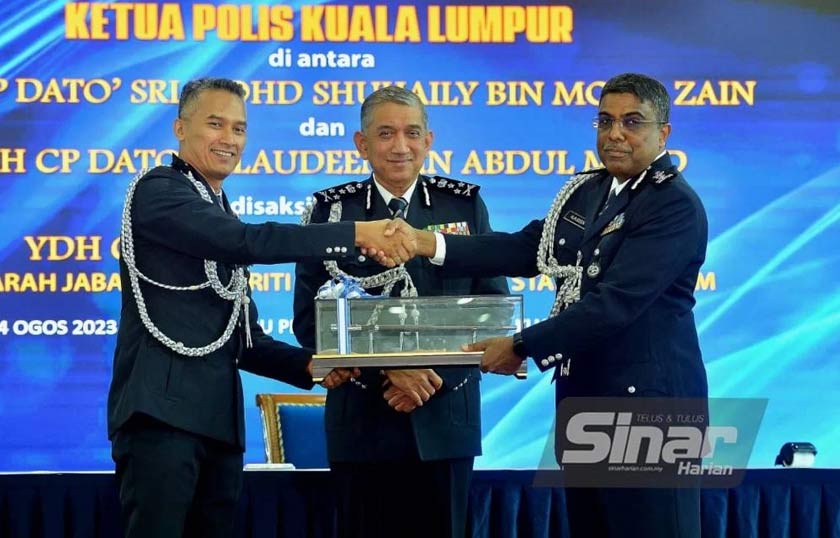 Mohd Shuhaily (kiri) menyerahkan simbolik tongkat kuasa kepada Allaudeen sambil disaksikan Azri (tengah) ketika majlis serah terima tugas di IPK Kuala Lumpur pada Isnin. - Foto Sinar Harian /ASRIL ASWANDI SHUKOR