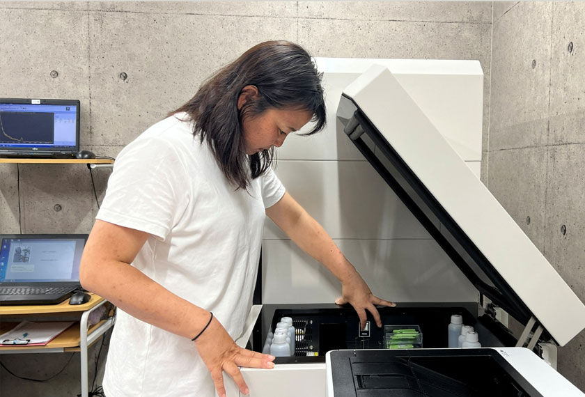 Ai Kimura, secretary-general of Tarachine measures radiation levels in collected seawater at their lab in Iwaki, Fukushima Prefecture, Japan. - REUTERS
