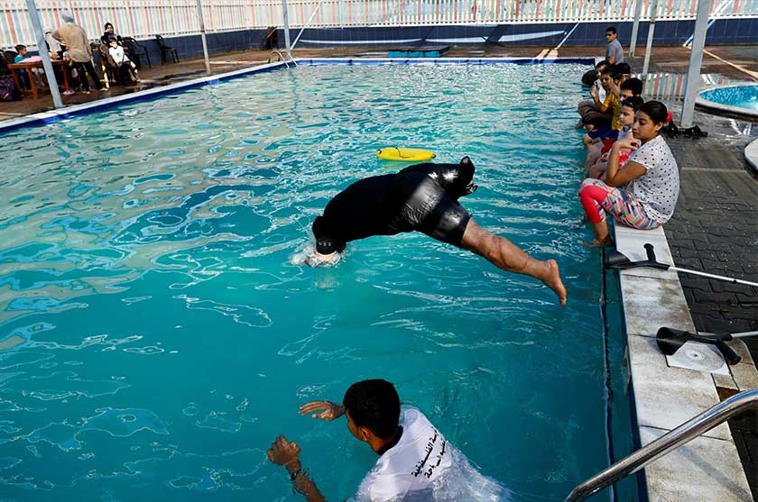 Majdi El-Tattar's Palestinian Swimming Academy holds its classes in a local pool and its students include youngsters and adults alike. - REUTERS
