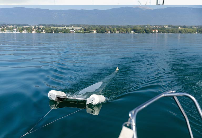 A device of NGO Oceaneye collects plastic fragments in the water of Lake Leman in Founex, near Geneva, Switzerland. - REUTERS