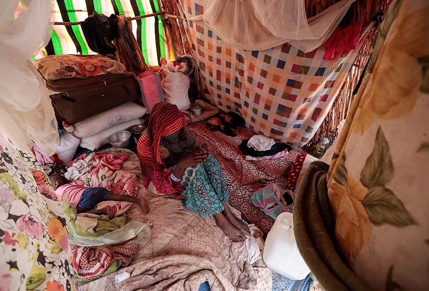 A 24-year-old mother, who said she became pregnant after two gunmen assaulted her in El Geneina, West Darfur, poses next to her toddler inside a makeshift shelter in Adre, Chad. - REUTERS/Zohra Bensemra