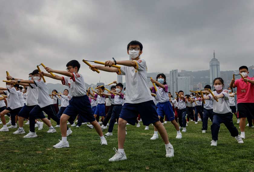 Heung Yee Kuk Yuen Long District Secondary School students attend a nunchaku performance event by the sea, in a tribute to the late martial artist and actor Bruce Lee, ahead of National Security Education Day, in Hong Kong, China. - REUTERS