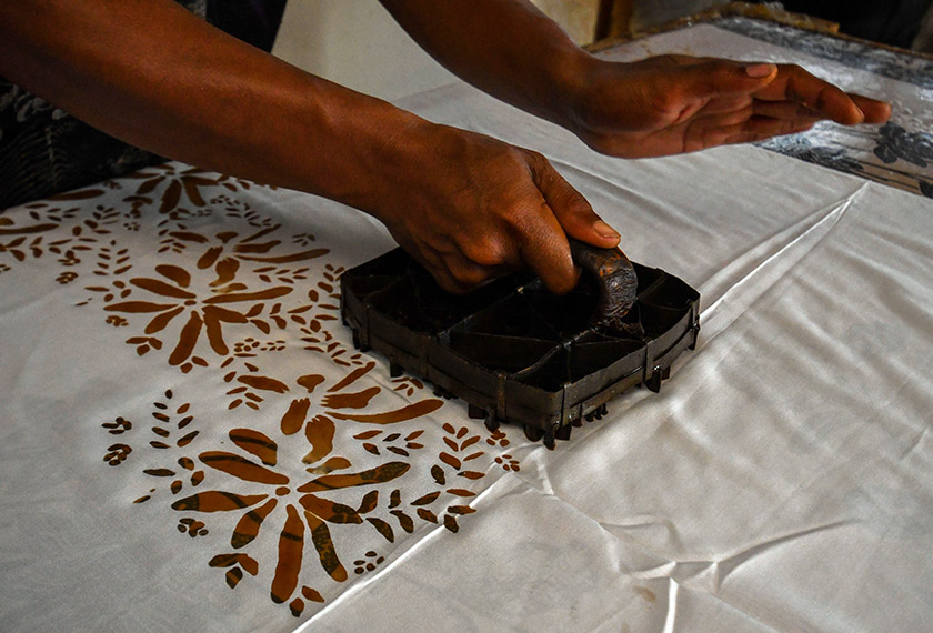 Pekerja batik Mohd Arif Maliki melakukan proses menerap batik pada kain. --fotoBERNAMA