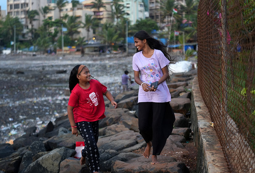 Maleesha Kharwa, 15, a model and Instagram Influencer, strolls with her cousin Liza Kharwa along a seashore in Mumbai, India. - REUTERS
