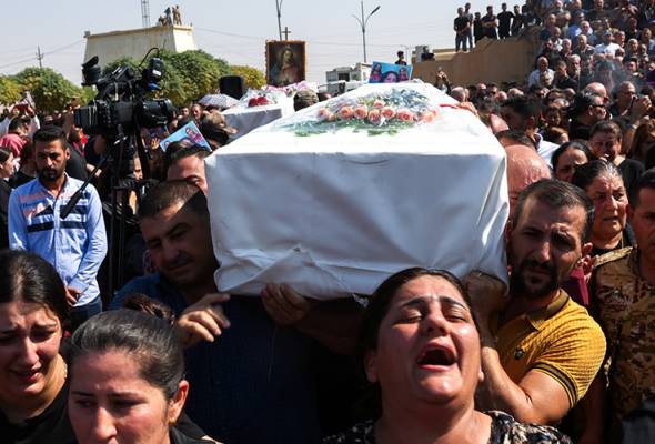 Mourners demand accountability, bury loved ones after Iraq wedding ...