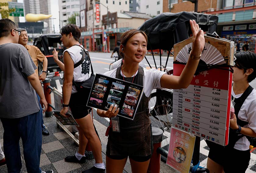 Rickshaw puller Shiori Yoshida, 28, attracts tourists to the guided tour at the Asakusa district in Tokyo, Japan. - REUTERS