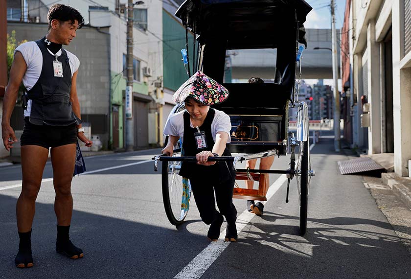 Trainee Yumeka Sakurai, 20, receives rickshaw driving lessons from her colleagues in the Asakusa district, Tokyo, Japan. Reuters