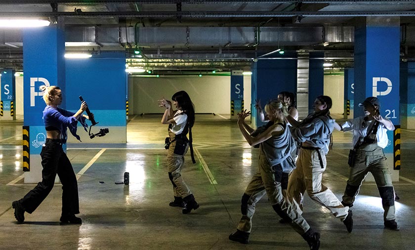 Members of the band GeneSiS dance while they record a one-take cover dance video, in a shopping mall in Moscow, Russia. - REUTERS