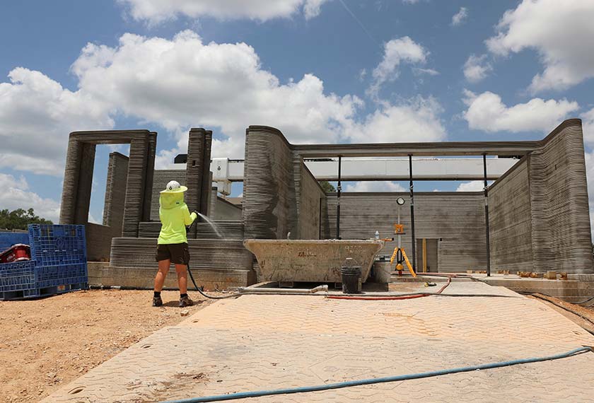 A drone image shows a 3D printer printing the walls of a home under construction in Georgetown, Texas. - REUTERS