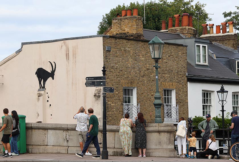 People view a new artwork by the British artist Banksy, in Kew, west London, Britain. - REUTERS