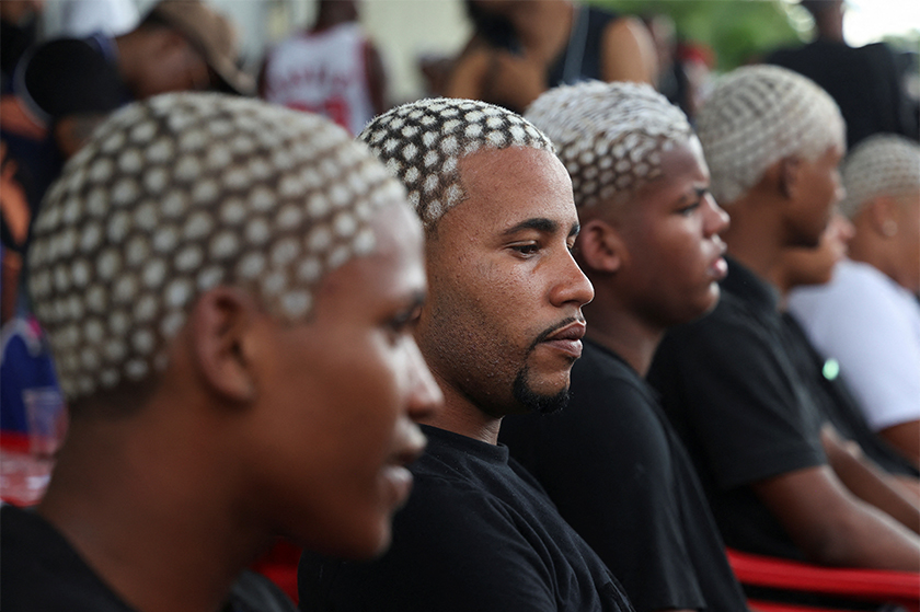 Men with colour-treated hair sit during a barbers' battle contest for best haircut in Rio de Janeiro, Brazil. - REUTERS