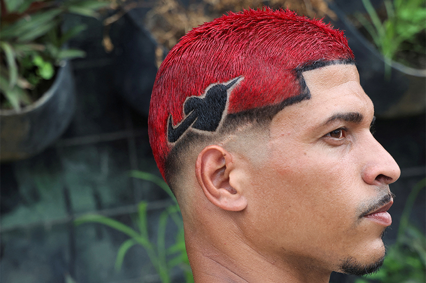 A man shows one of the winning haircuts during a barbers' battle contest for best haircut in Rio de Janeiro, Brazil. - REUTERS