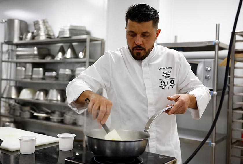 The executive chef for the Paris 2024 Olympic Games, Charles Guilloy, prepares a dish that will be served to athletes competing in the Paris 2024 Olympics and Paralympics, in Rungis, near Paris, France. - REUTERS/Sarah Meyssonnier