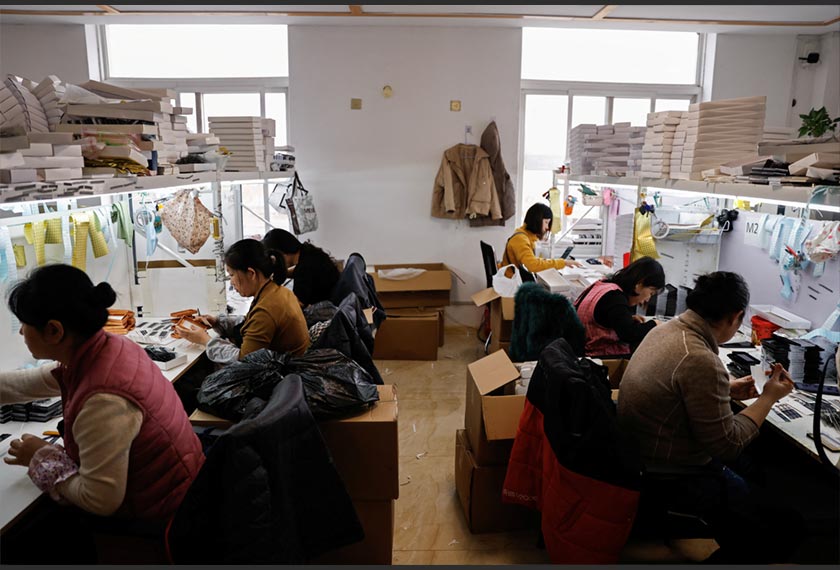 Workers work on a production line manufacturing false eyelashes at a workshop of Monsheery, in Pingdu, Shandong province, China. - REUTERS