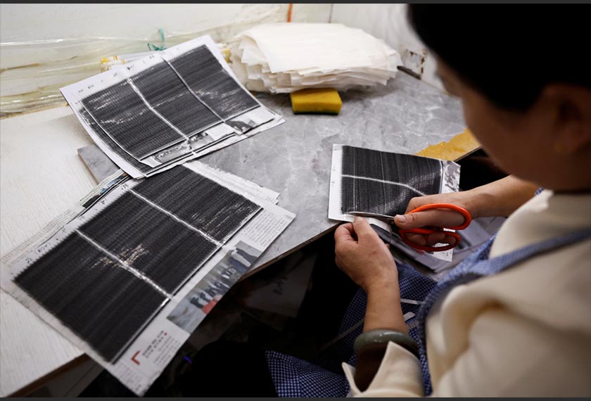 A worker works on a production line manufacturing false eyelashes at a workshop of Monsheery, in Pingdu, Shandong province, China. - REUTERS