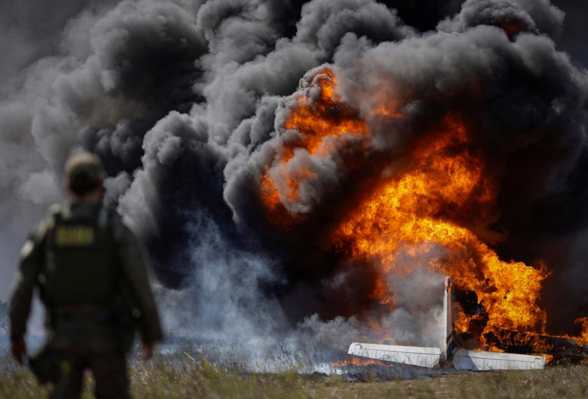 Aeroplanes belonging to illegal miners burn during an operation by members of the Special Inspection Group from the Brazilian Institute of Environment and Renewable Natural Resources (IBAMA) against illegal mining in Yanomami Indigenous land, at an airstrip on a farm in rural Boa Vista, Roraima state, Brazil. - REUTERS/Ueslei Marcelino 