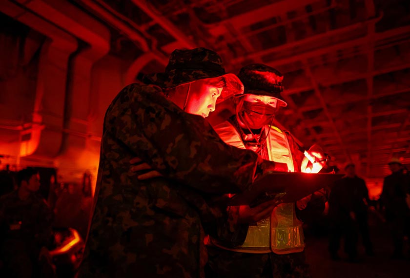Hikari Maruyama, 38, and Runa Kurosawa, 20, soldiers with the Japanese Ground Self-Defense Force's Amphibious Rapid Deployment Brigade (ARDB), Japan's first marine unit since World War Two, take part in military training inside the Japanese Maritime Self-Defense Force's amphibious transport ship JS Osumi (LST-4001) in waters close to Okinawa, Japan. - REUTERS