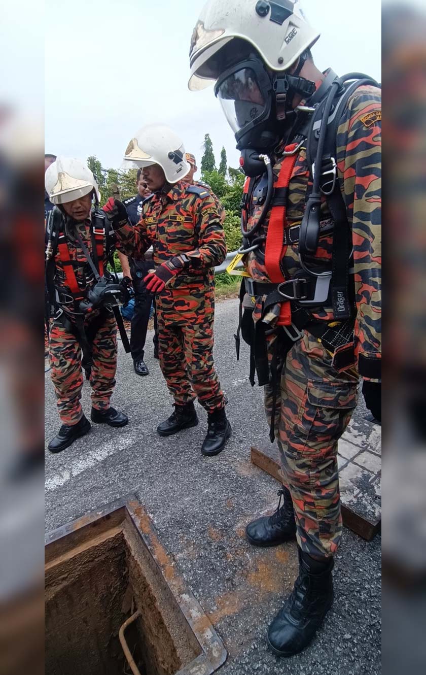 Dua lelaki ditemukan maut setelah terperangkap di dalam lubang pembetung di depan Sekolah Menengah Kebangsaan (SMK) Paya Kemunting, Jitra. - Foto JBPM