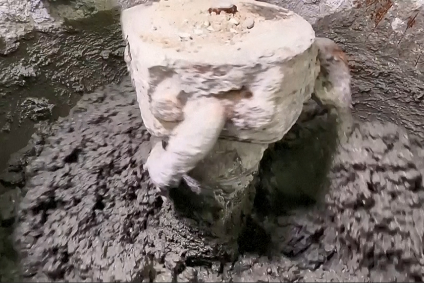Coffee grounds going into concrete mixer, Melbourne, Australia. - Screenshot/REUTERS