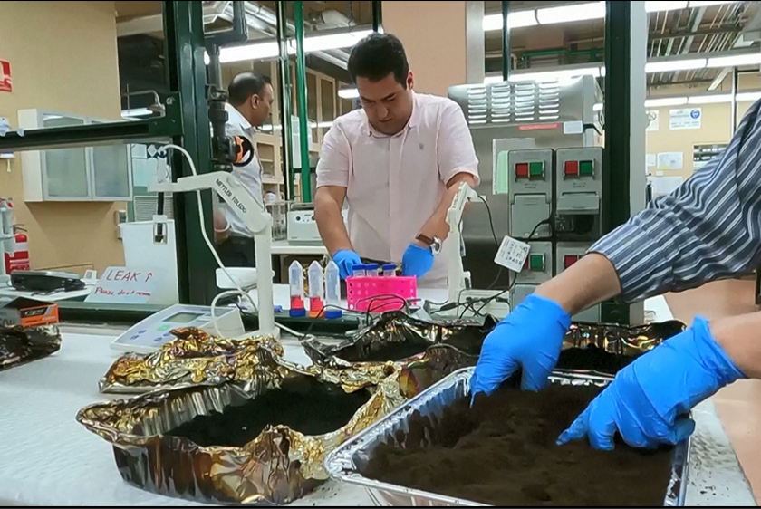 Coffee grounds being wrapped in foil container at RMIT University lab, Melbourne, Australia. - Screenshot/REUTERS