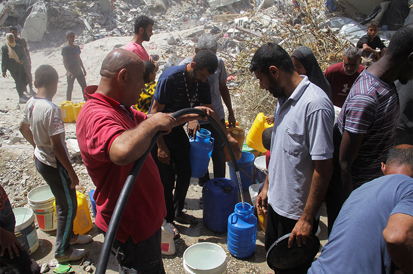 Displaced Palestinians fill containers with water as Gazan families struggle with water pollution and scarcity, amid the ongoing conflict between Israel and Hamas, in Jabalia refugee camp, in the northern Gaza Strip. - REUTERS