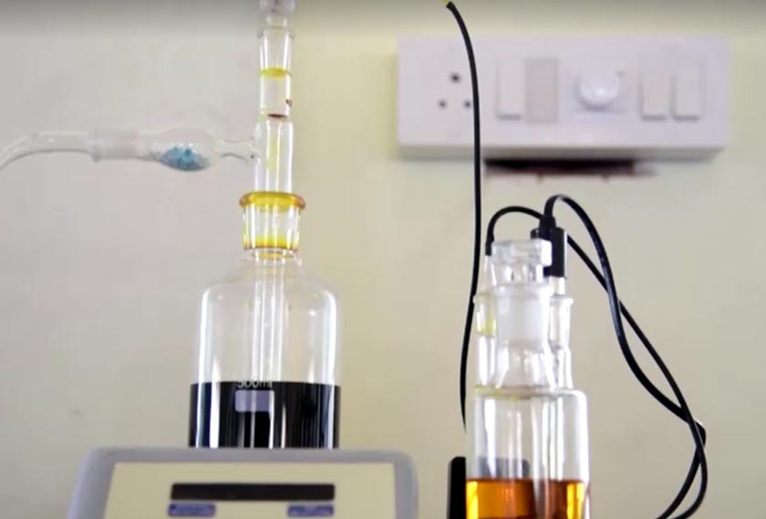 Beakers holding liquids used to produce indelible ink, Mysore, Karnataka, India. - Screengrab/REUTERS