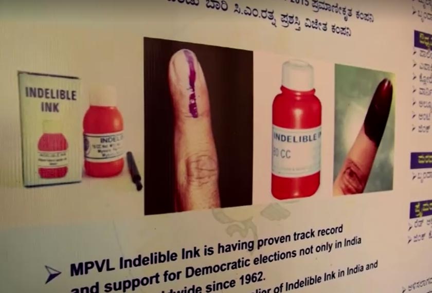 Sign board with information and photographs of indelible ink's use, Mysore, Karnataka, India. - REUTERS