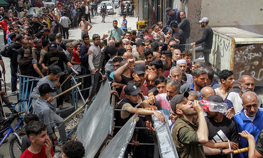 Palestinians queue up to buy bread from recently reopened Ajour bakery, amid the ongoing conflict between Israel and Hamas, in Gaza City. - REUTERS