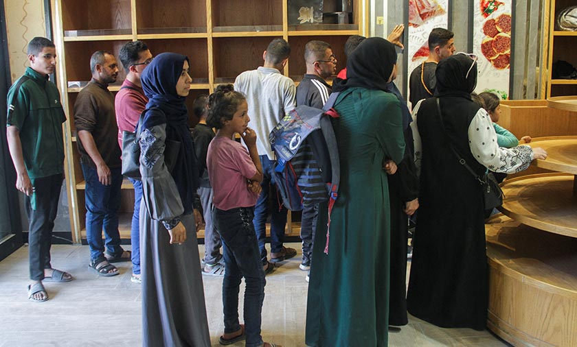Palestinian woman Asmaa Al-Belbasi waits to buy bread from recently reopened Al-Sharq bakery, amid the ongoing conflict between Israel and Hamas, in Gaza City. - REUTERS