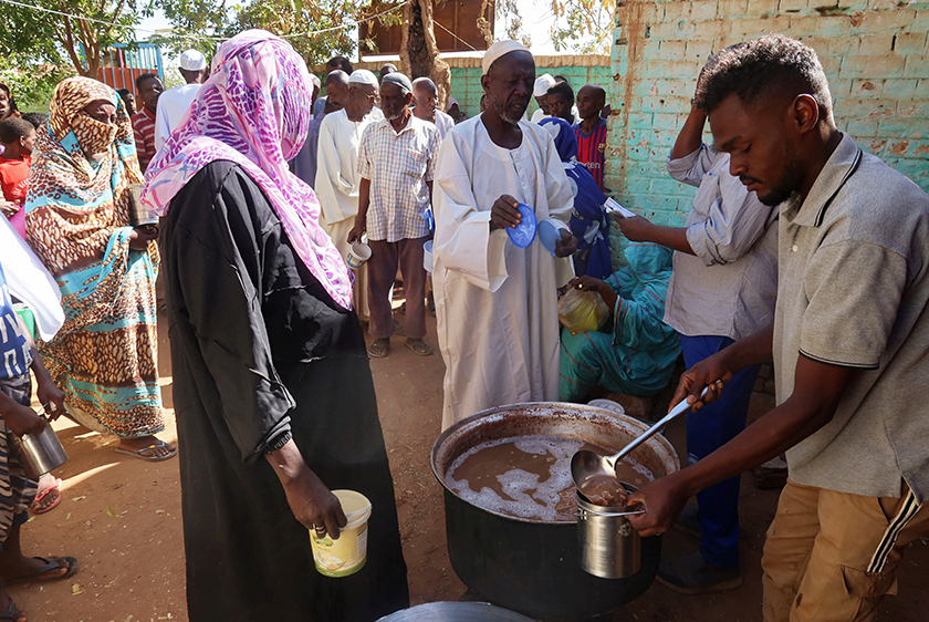 Volunteers distribute food to residents and displaced people in Omdurman, Sudan. - REUTERS
