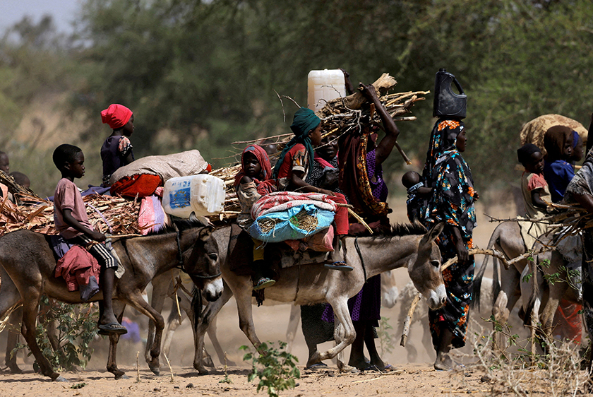 Sudanese refugees who fled the violence in Sudan's Darfur region and newly arrived ride their donkeys looking for space to temporarily settle, near the border between Sudan and Chad in Goungour, Chad. - REUTERS