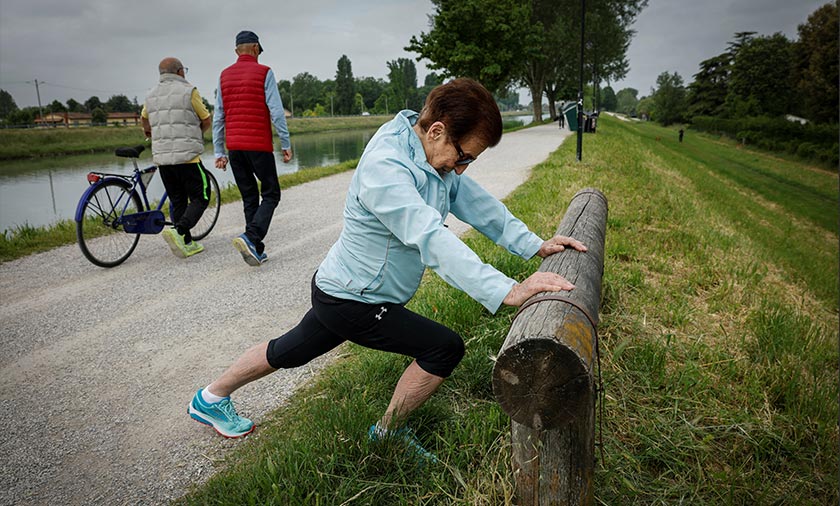Italian master runner Emma Maria Mazzenga, 90, stretches before running, at a park in Padua, Italy. - REUTERS