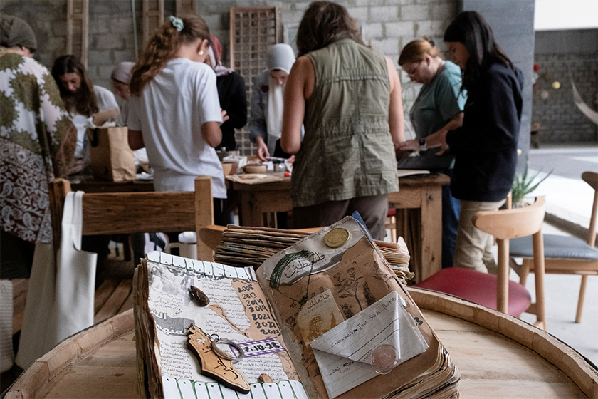 Salma talks about her journaling and how each person in the workshop can create their own journal and document their journey, in one of the workshops that she began in Egypt after leaving Gaza with her brother, in Cairo, Egypt. - REUTERS