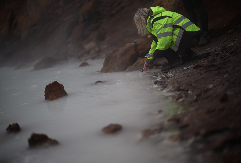 Michelle Parks, a volcanologist at the Icelandic Meteorological Office, measures the temperature of the Viti crater lake at Askja volcano, in Vatnajokull National Park, Iceland. - REUTERS/Stoyan Nenov 