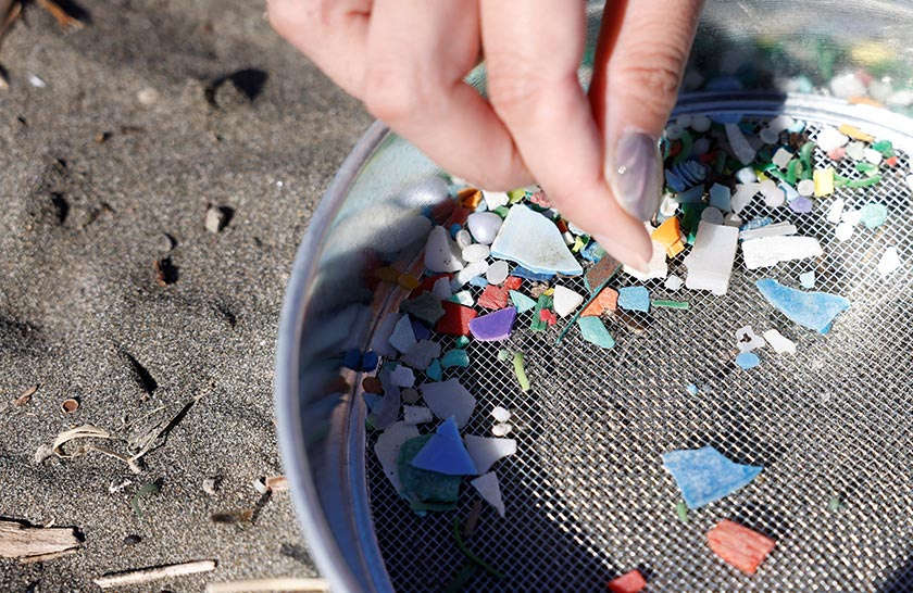 Japanese manicurist Naomi Arimoto collects plastic waste from the sand at a beach in Chigasaki, Kanagawa Prefecture, Japan. - REUTERS/Manami Yamada