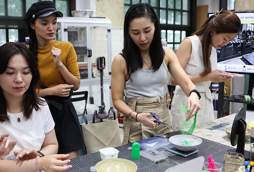 Debbie Wu cuts up plastic waste to be used as part of her sunglasses at Trash Kitchen in Taipei, Taiwan. - REUTERS
