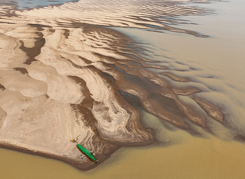 A drone view shows Reis Santo Vieira da Silva as a river dweller builds a canoe on the sandbanks of Madeira River during the worst drought of the river in history, in Humaita, Amazonas state, Brazil, September 7, 2024. - REUTERS
