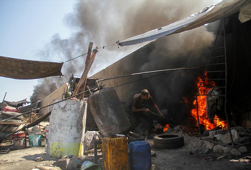 A Palestinian man burns plastic waste to produce alternative fuel amid scarcity as the Israel-Hamas conflict continues, in northern Gaza Strip. - REUTERS