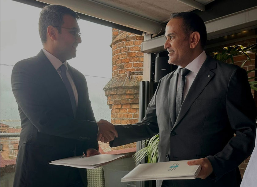 two man shaking hands over signing of documents